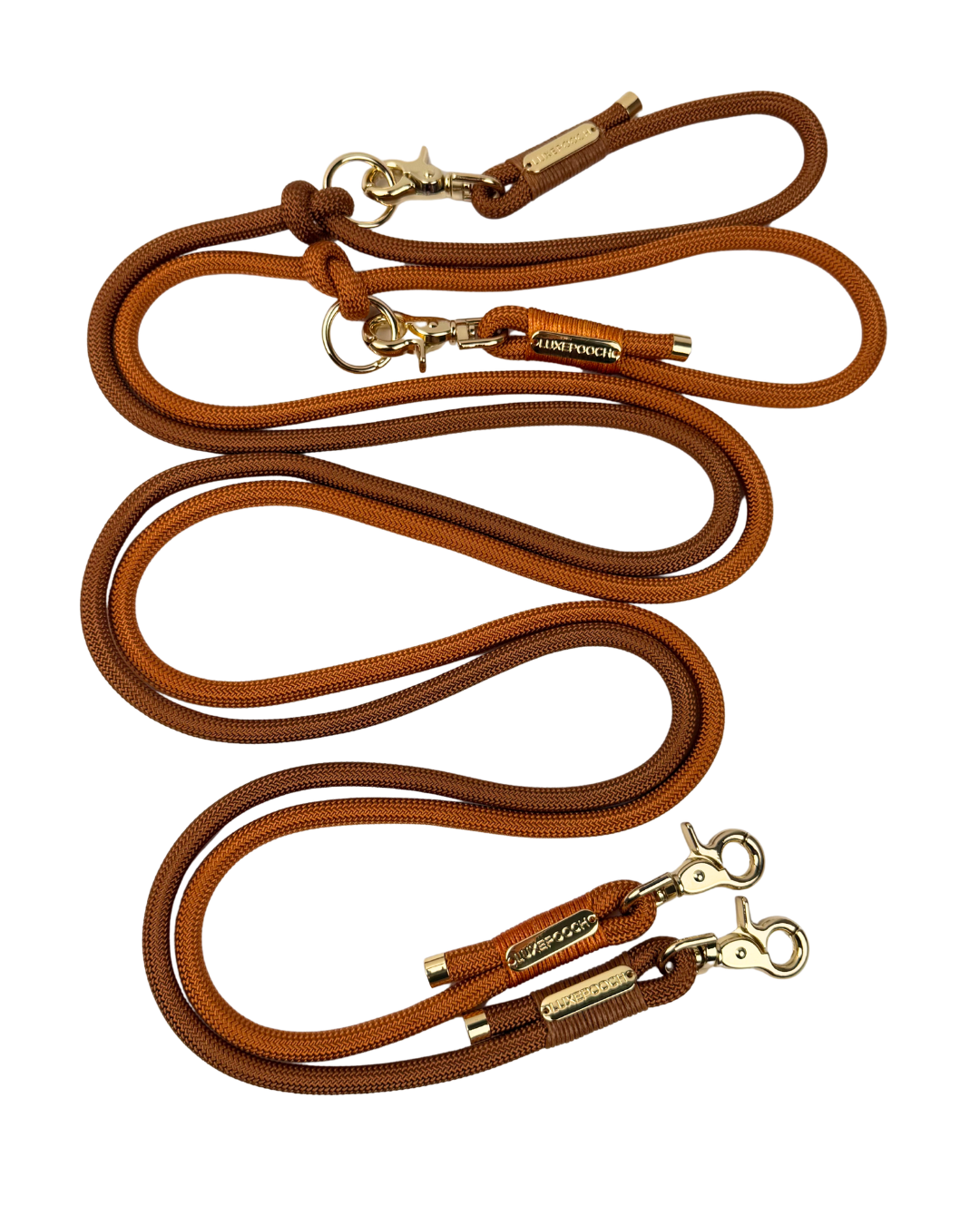 Brown and orange braided rope dog leashes with gold-tone metal hardware and leather accents, arranged on a plain white background.