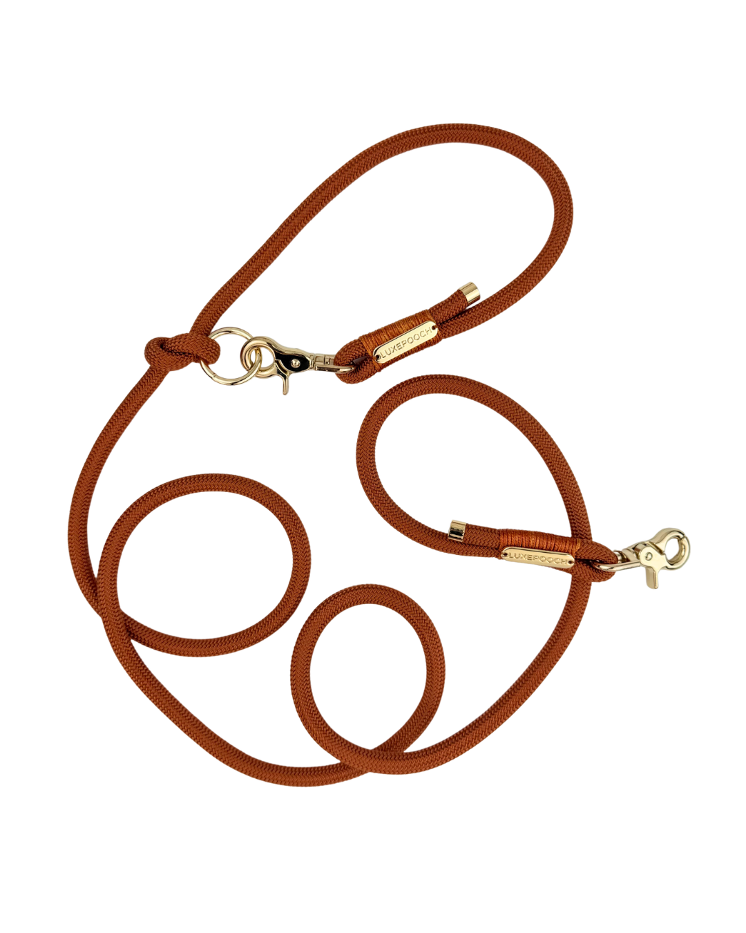 A orange braided rope dog leash with gold-tone metal hardware, including snap hooks and a small gold brand tag, displayed on a clean white background.
